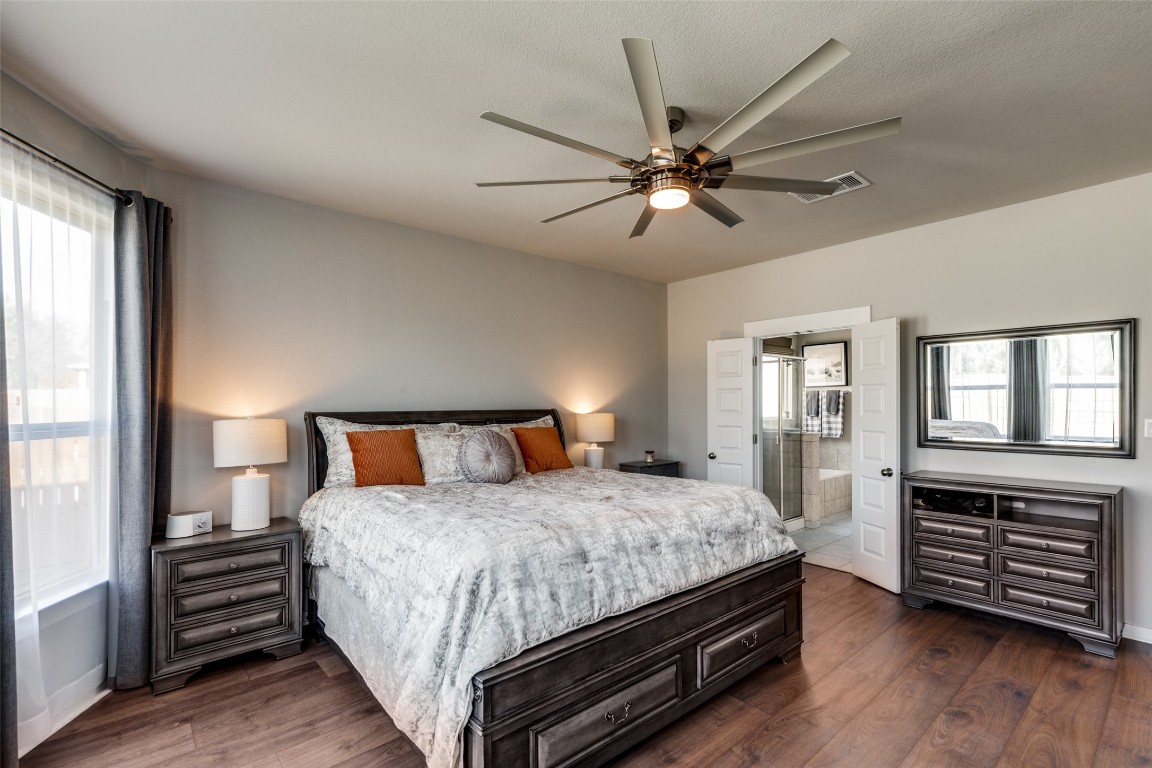 125 Syrah Court Leander, TX 78641 - Photo 14 of 25 a bedroom with a bed and wooden floor