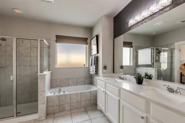 a bathroom with a tub a sink and mirror