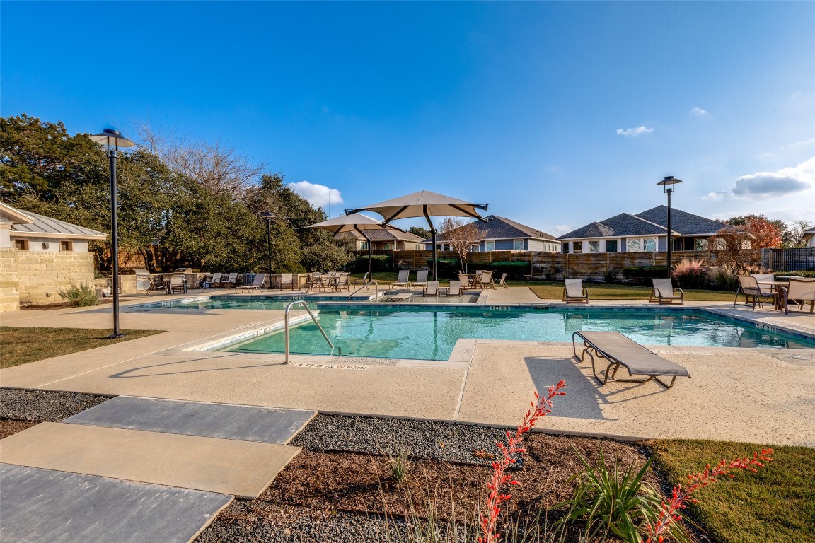 125 Syrah Court Leander, TX 78641 - Photo 25 of 25 a view of a swimming pool with lawn chairs and plants