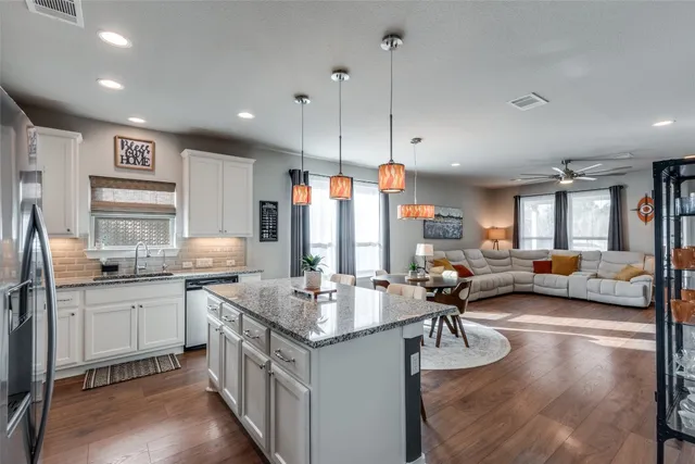 a kitchen with sink stove and cabinets