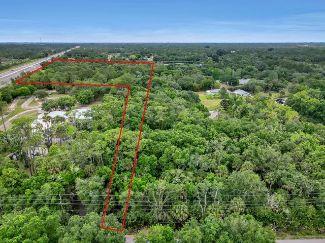 an aerial view of a houses with a yard
