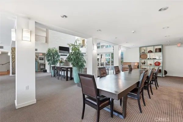 a room with pool table and windows