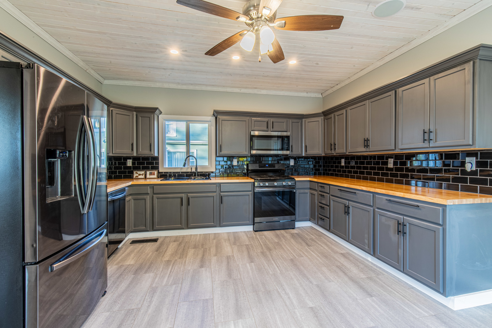 15 South Vernon Street Princeton, IL 61356 - Photo 13 of 28 a kitchen with stainless steel appliances granite countertop a refrigerator a stove top oven a sink and dishwasher with wooden floor