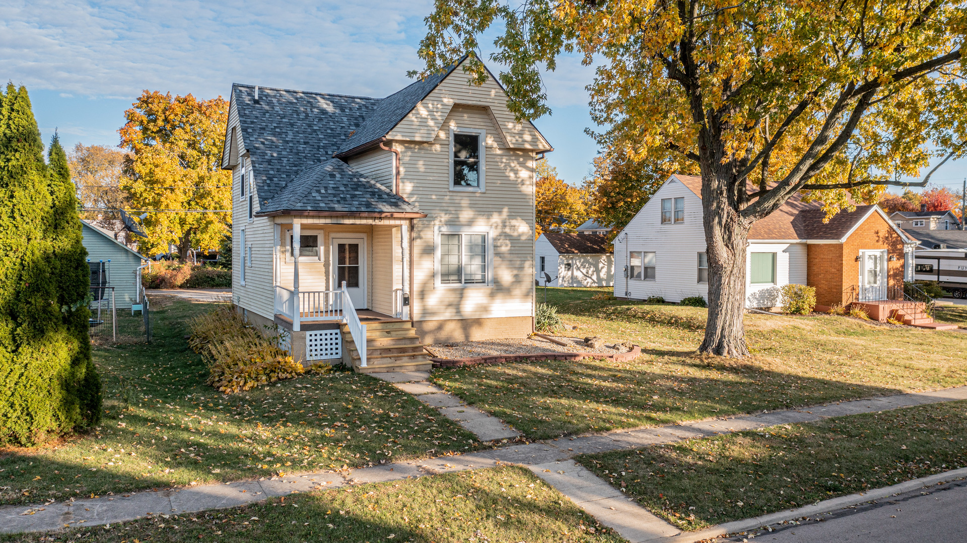 15 South Vernon Street Princeton, IL 61356 - Photo 2 of 28 a view of a white house next to a yard with big trees