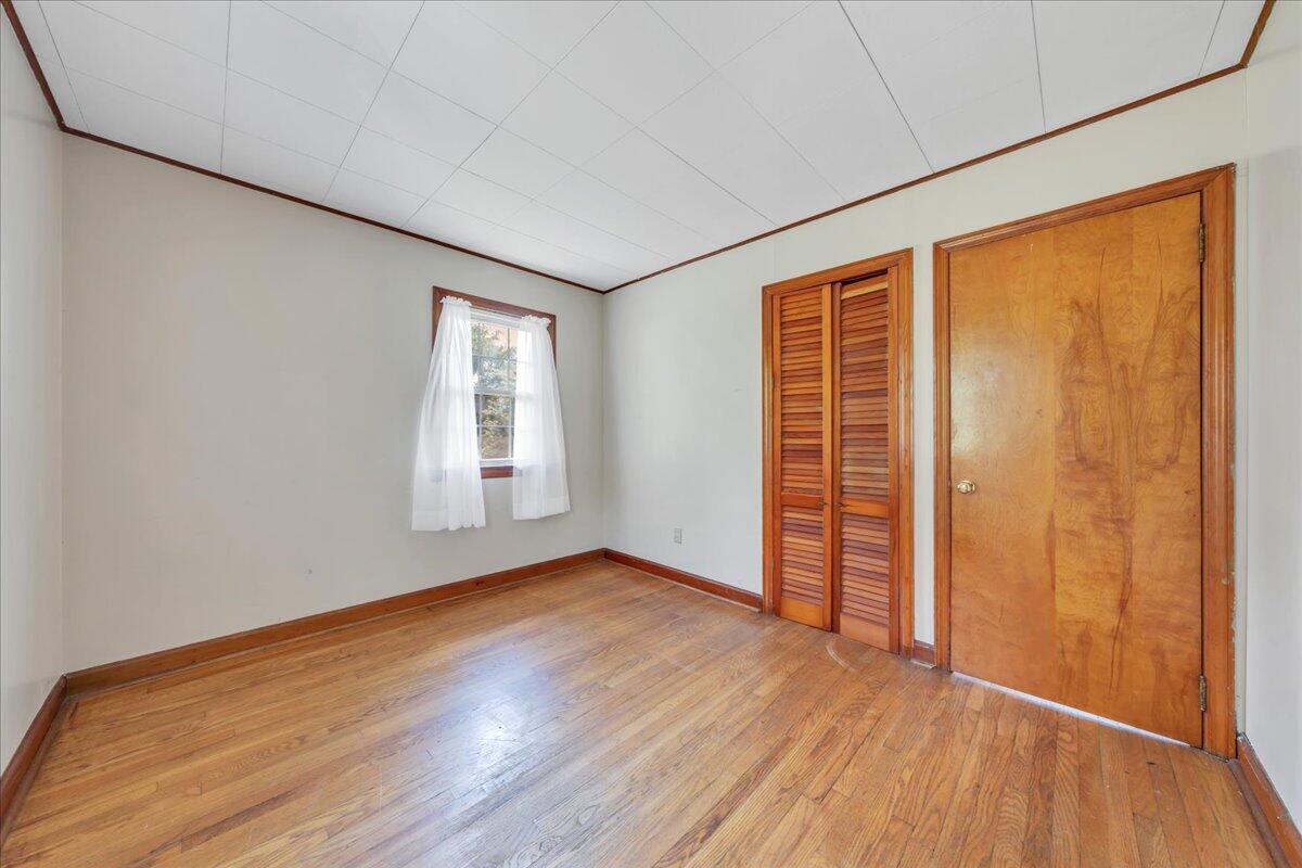 201 Long Avenue Covington, VA 24426 - Photo 17 of 43 a view of an empty room with wooden floor and a window