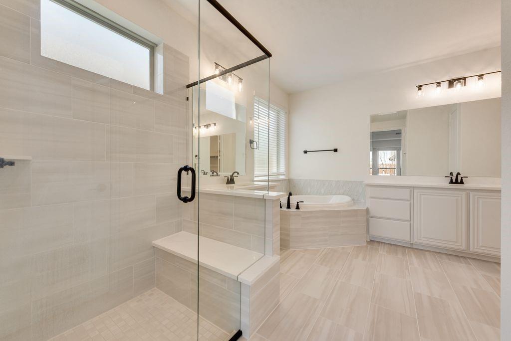 809 Turnbull Avenue Justin, TX 76247 - Photo 15 of 22 a bathroom with a double vanity sink a mirror and shower