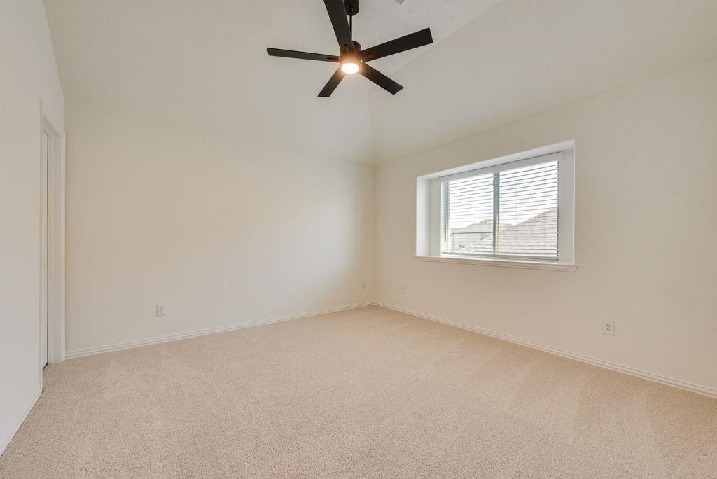 809 Turnbull Avenue Justin, TX 76247 - Photo 18 of 22 an empty room with a window and a fan