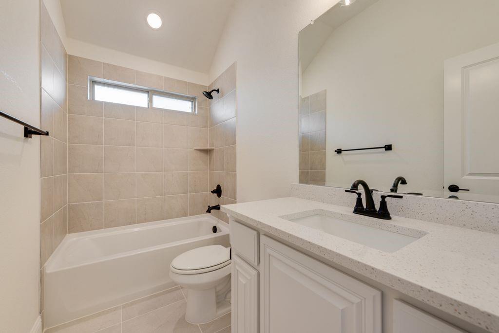 809 Turnbull Avenue Justin, TX 76247 - Photo 19 of 22 a bathroom with a sink a toilet and shower