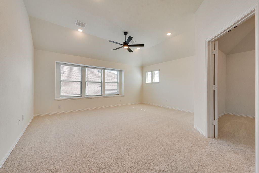 809 Turnbull Avenue Justin, TX 76247 - Photo 20 of 22 an empty room with windows and ceiling fan