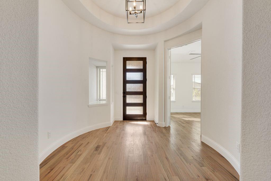 809 Turnbull Avenue Justin, TX 76247 - Photo 2 of 22 an empty room with wooden floor closet and windows