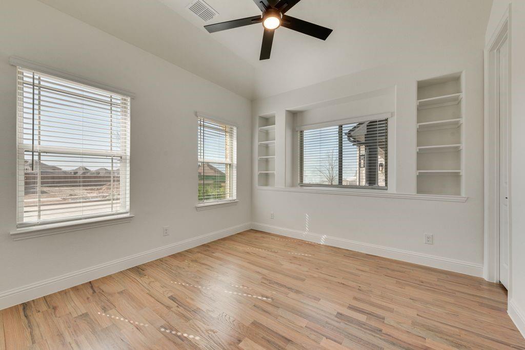 809 Turnbull Avenue Justin, TX 76247 - Photo 3 of 22 a view of empty room with wooden floor and fan