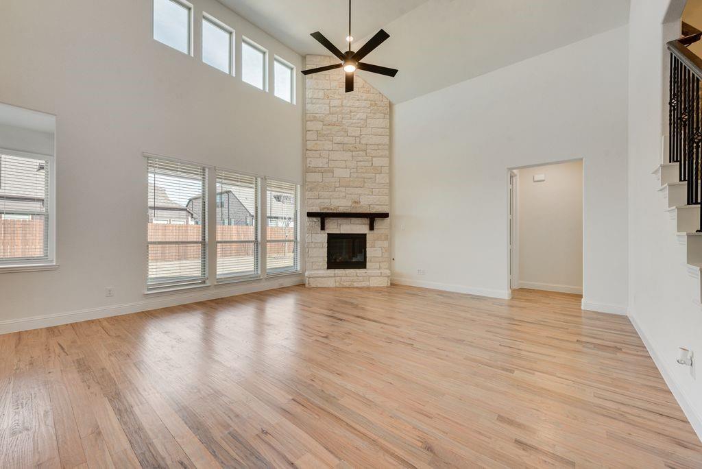 809 Turnbull Avenue Justin, TX 76247 - Photo 5 of 22 wooden floor in an empty room with a window