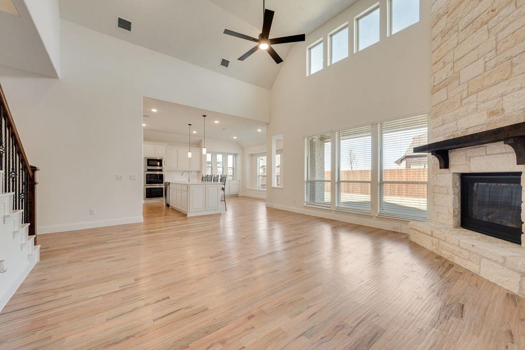 809 Turnbull Avenue Justin, TX 76247 - Photo 6 of 22 a view of an empty room with wooden floor and a fireplace
