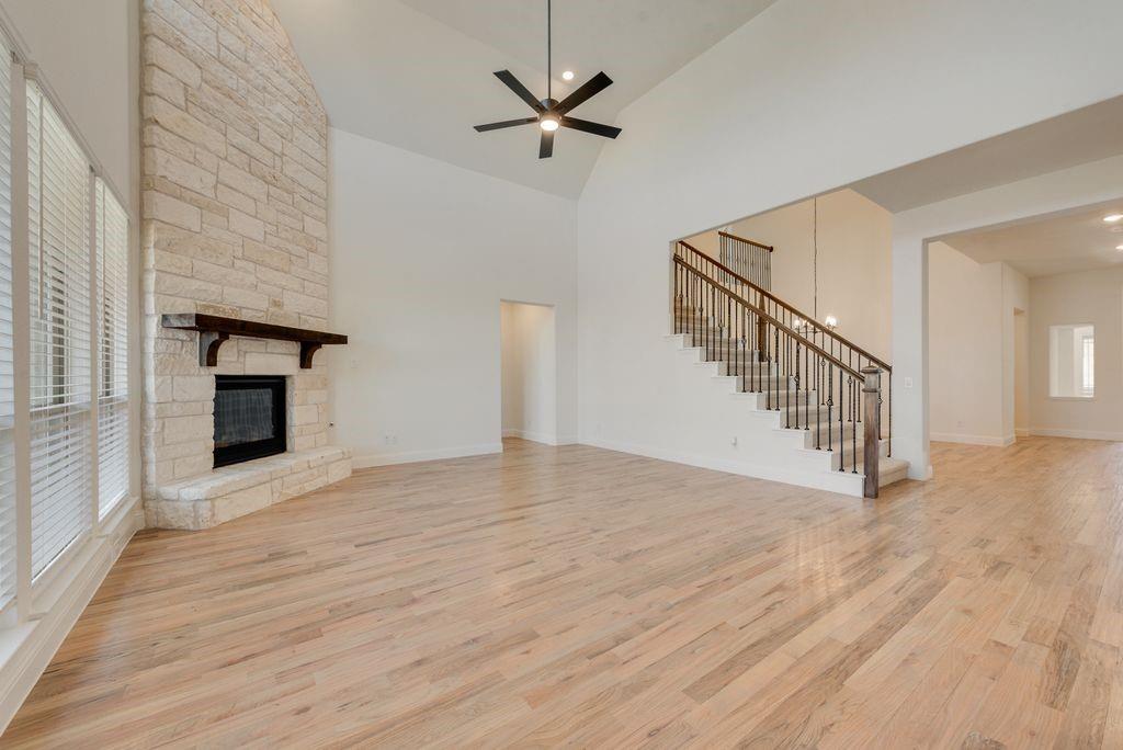 809 Turnbull Avenue Justin, TX 76247 - Photo 8 of 22 wooden floor in an empty room with a fireplace