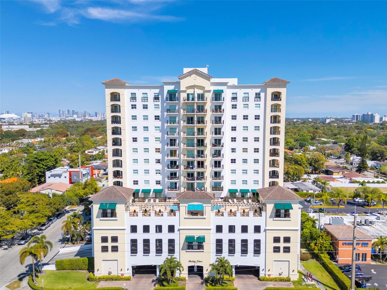 1627 Southwest 37th Avenue, Unit 207 Miami, FL 33145 - Photo 1 of 24 a view of a city with tall buildings