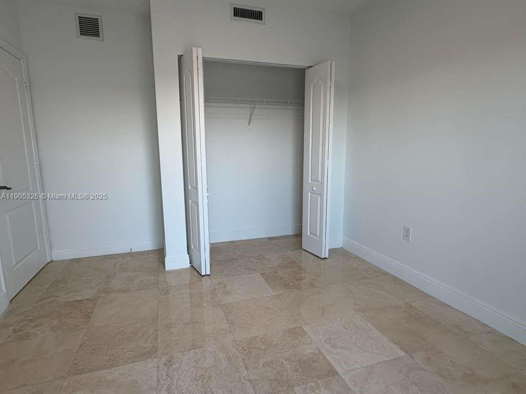 1627 Southwest 37th Avenue, Unit 207 Miami, FL 33145 - Photo 11 of 24 an empty room with closet area