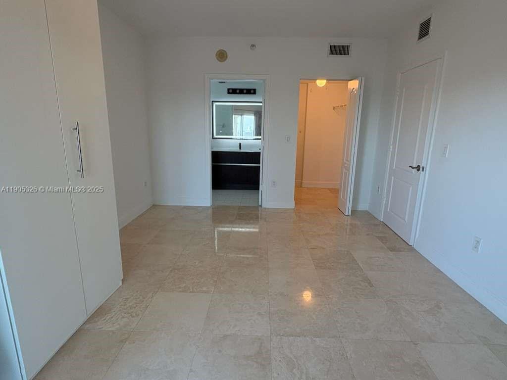 1627 Southwest 37th Avenue, Unit 207 Miami, FL 33145 - Photo 14 of 24 an empty room with windows and cabinet
