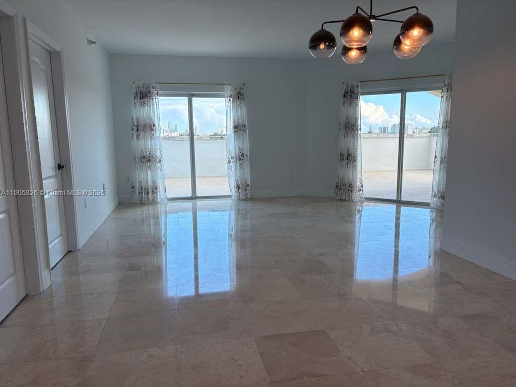 1627 Southwest 37th Avenue, Unit 207 Miami, FL 33145 - Photo 7 of 24 an empty room with sliding door and wooden floor