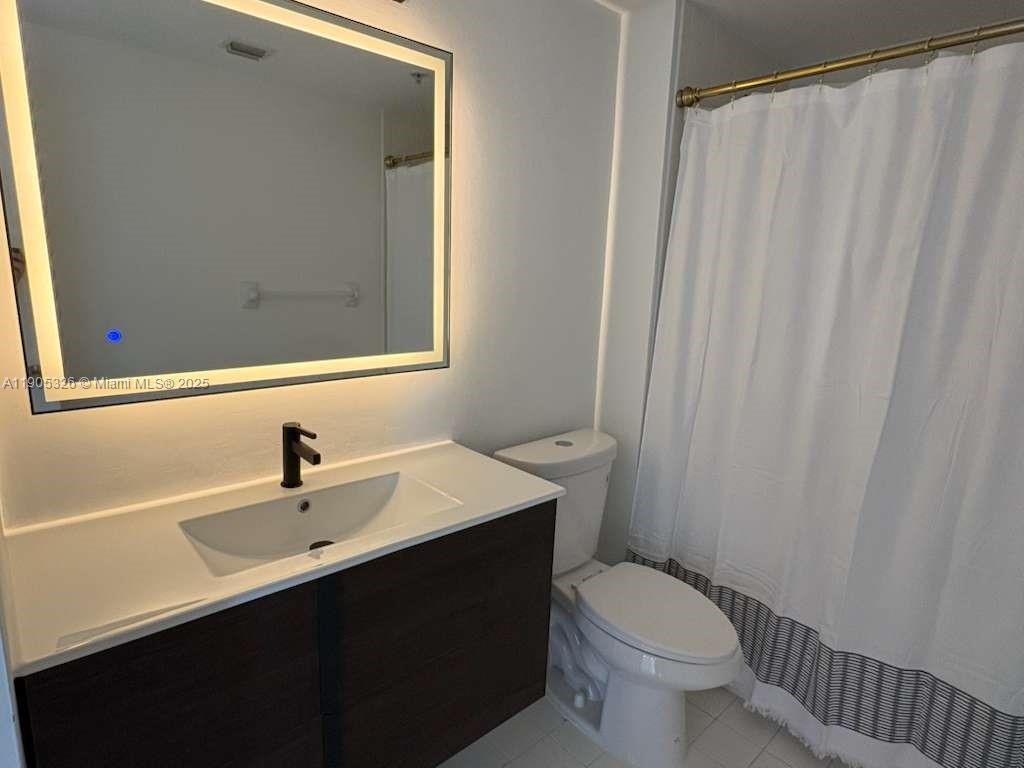 1627 Southwest 37th Avenue, Unit 207 Miami, FL 33145 - Photo 8 of 24 a bathroom with a sink a toilet and shower