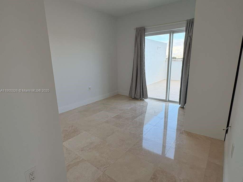 1627 Southwest 37th Avenue, Unit 207 Miami, FL 33145 - Photo 10 of 24 an empty room with a window