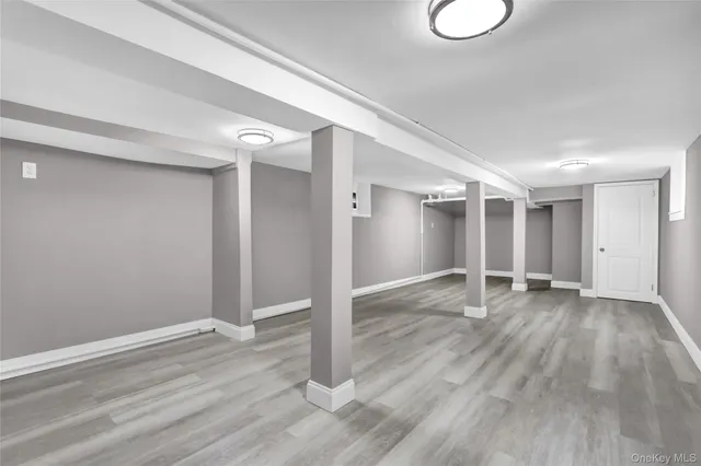 a view of a room with wooden floor and window