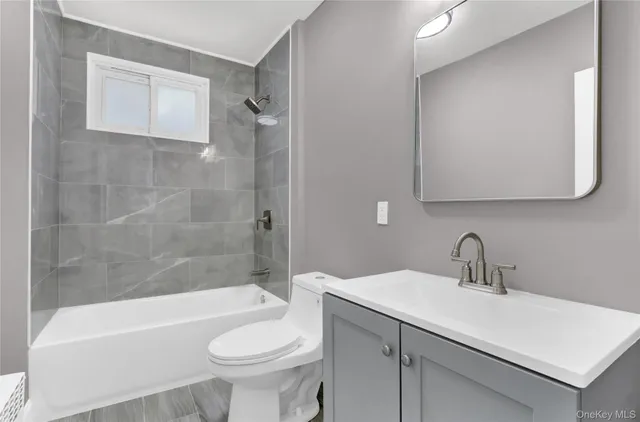 a bathroom with a sink a toilet and bathtub