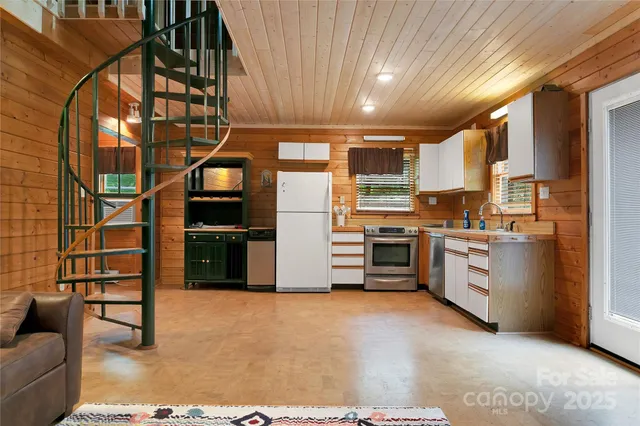 a kitchen with white cabinets and white appliances