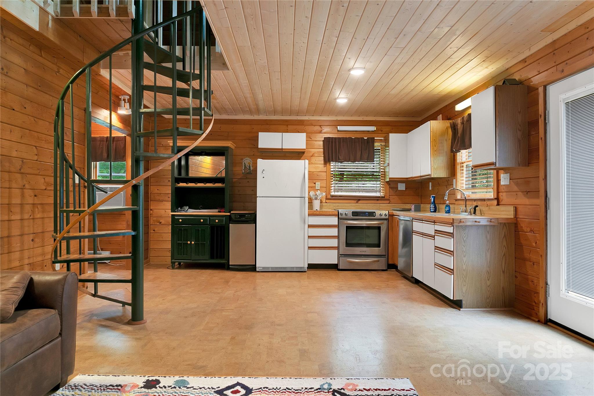 261 Franks Cove Road Brevard, NC 28712 - Photo 11 of 34 a kitchen with stainless steel appliances and white cabinets