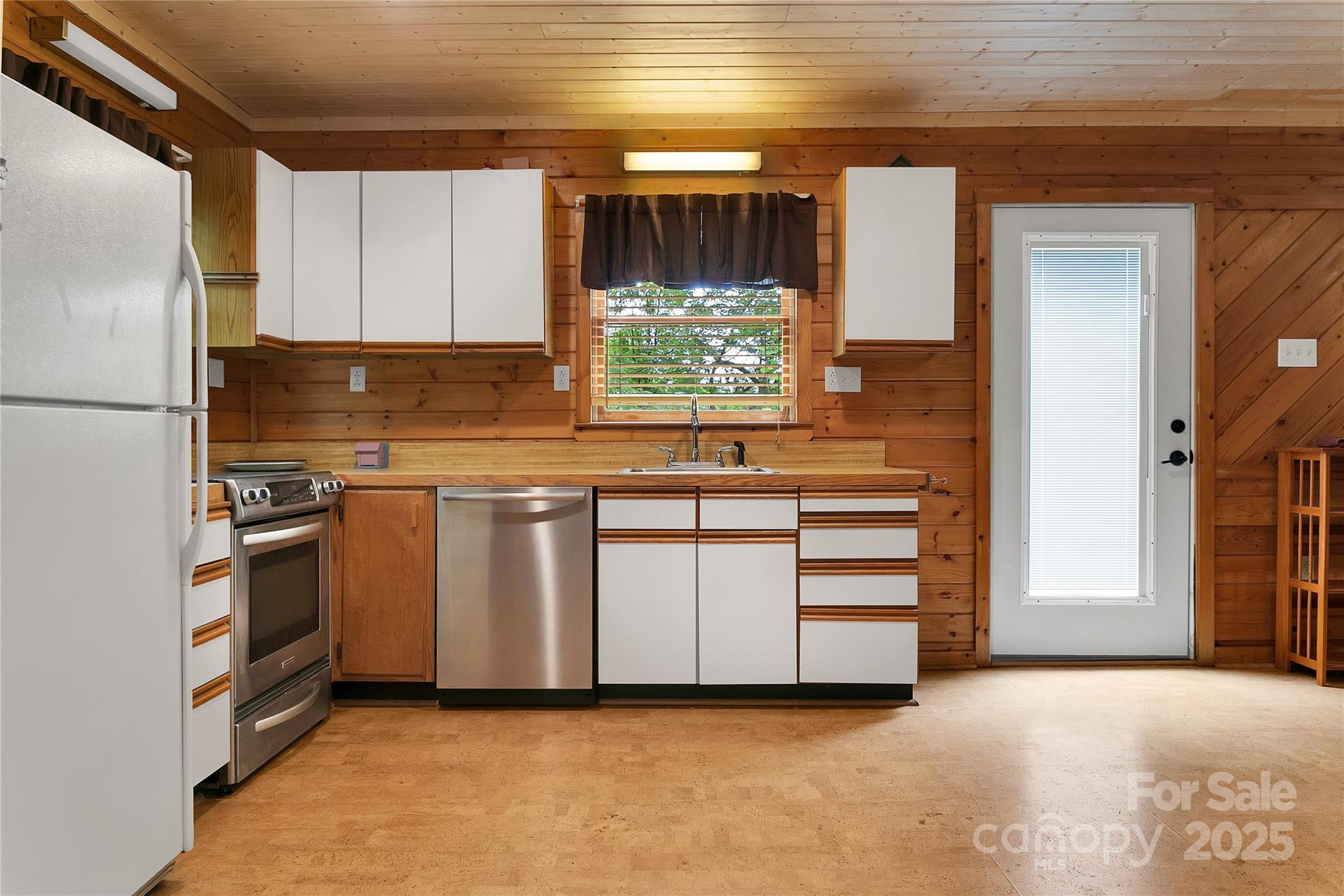 261 Franks Cove Road Brevard, NC 28712 - Photo 13 of 34 a kitchen with white cabinets and white appliances