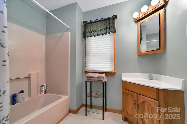 a bedroom with a bed next to a ceiling fan