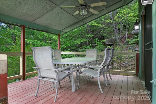 a view of balcony with wooden floor and fence