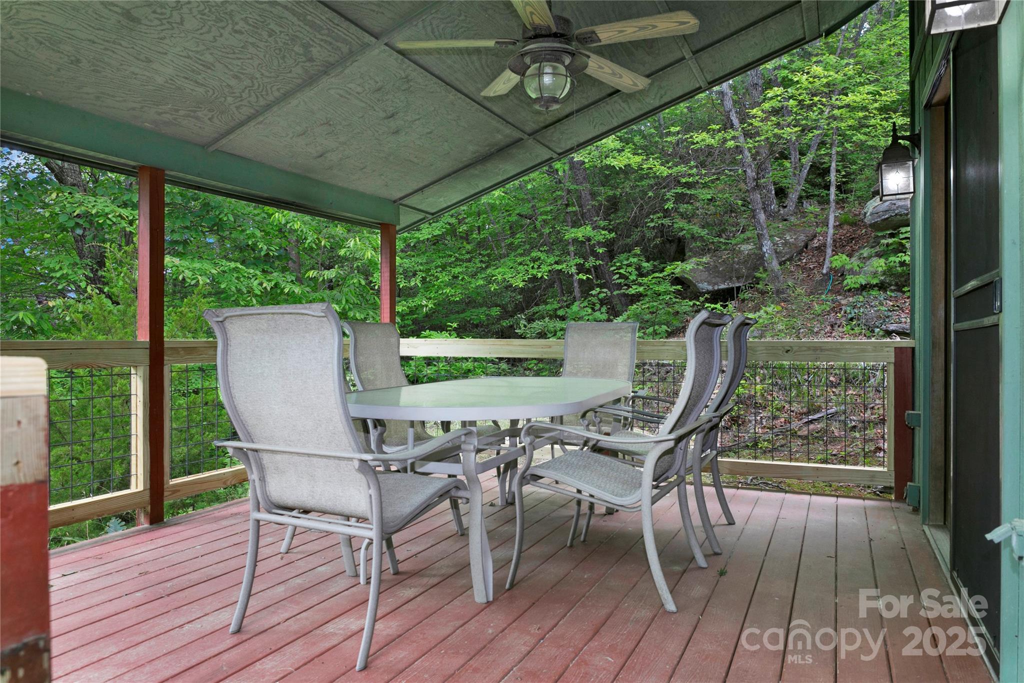 261 Franks Cove Road Brevard, NC 28712 - Photo 27 of 34 a view of a chairs and table in patio with wooden floor