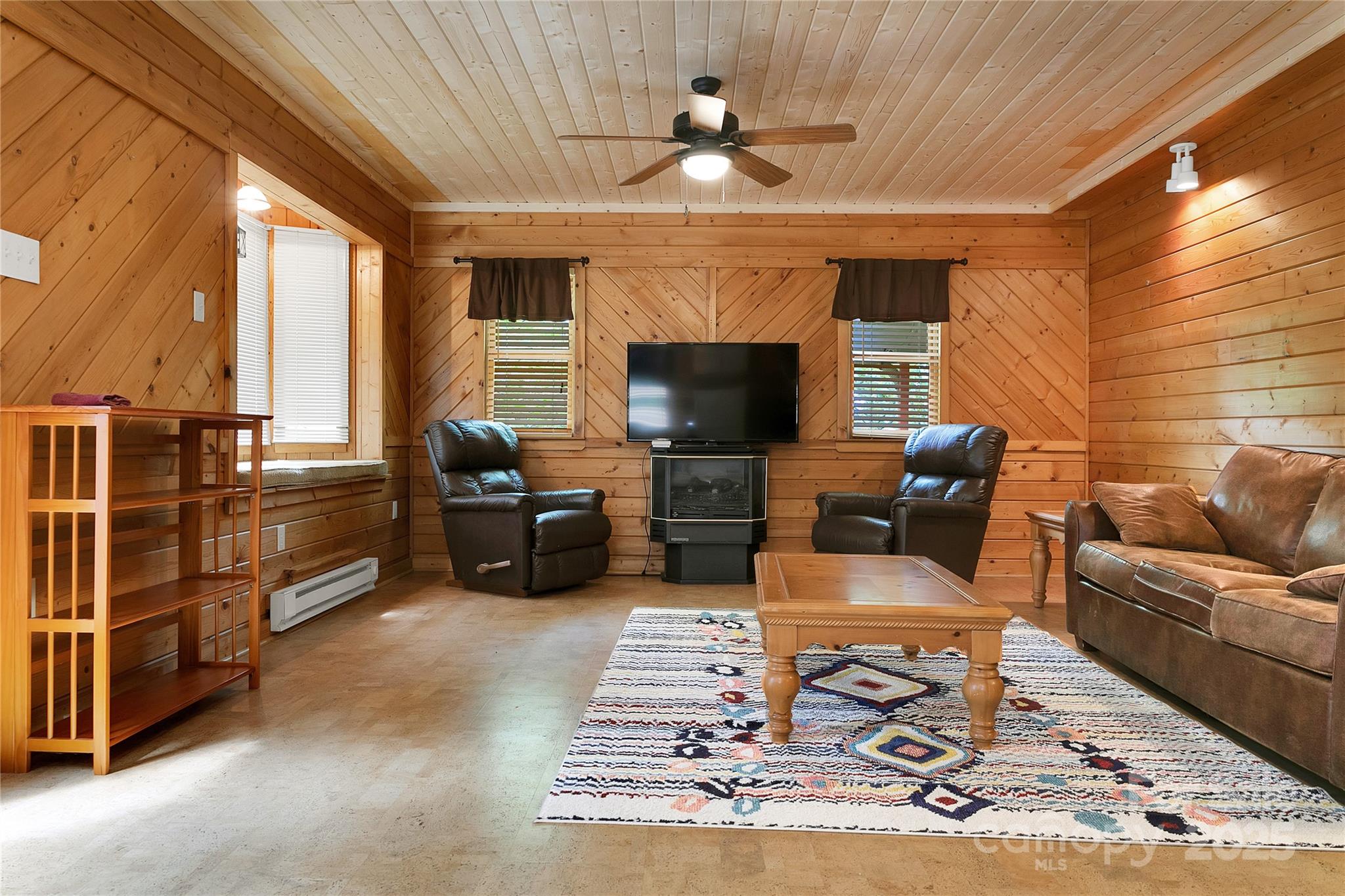 261 Franks Cove Road Brevard, NC 28712 - Photo 9 of 34 a living room with furniture and a fireplace