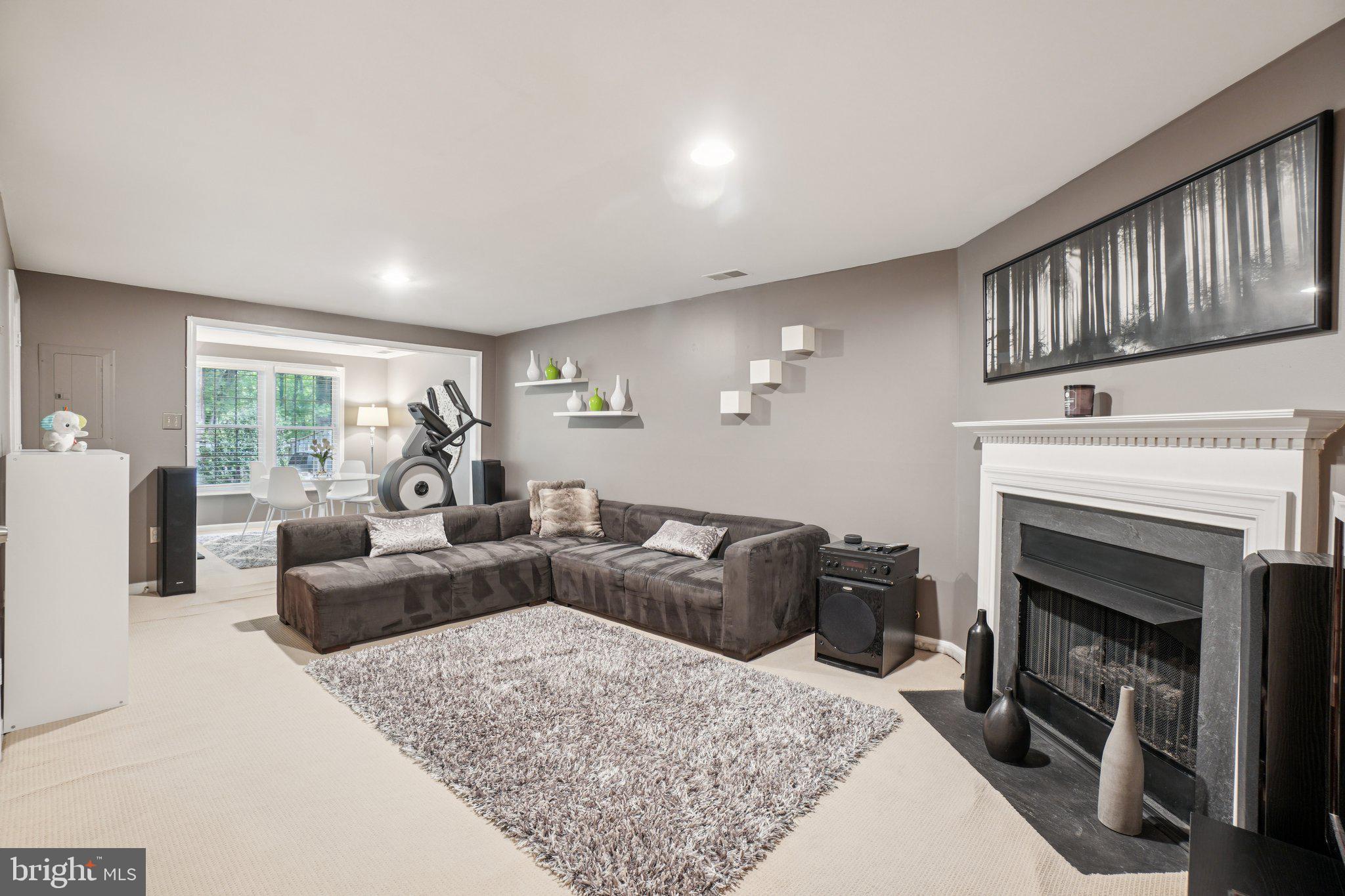 11742 Valley Ridge Circle Fairfax, VA 22033 - Photo 22 of 34 a living room with furniture a window and a fireplace