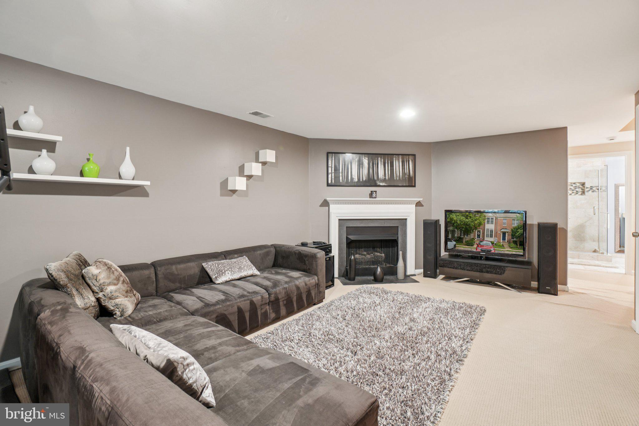 11742 Valley Ridge Circle Fairfax, VA 22033 - Photo 23 of 34 a living room with furniture a fireplace and a flat screen tv