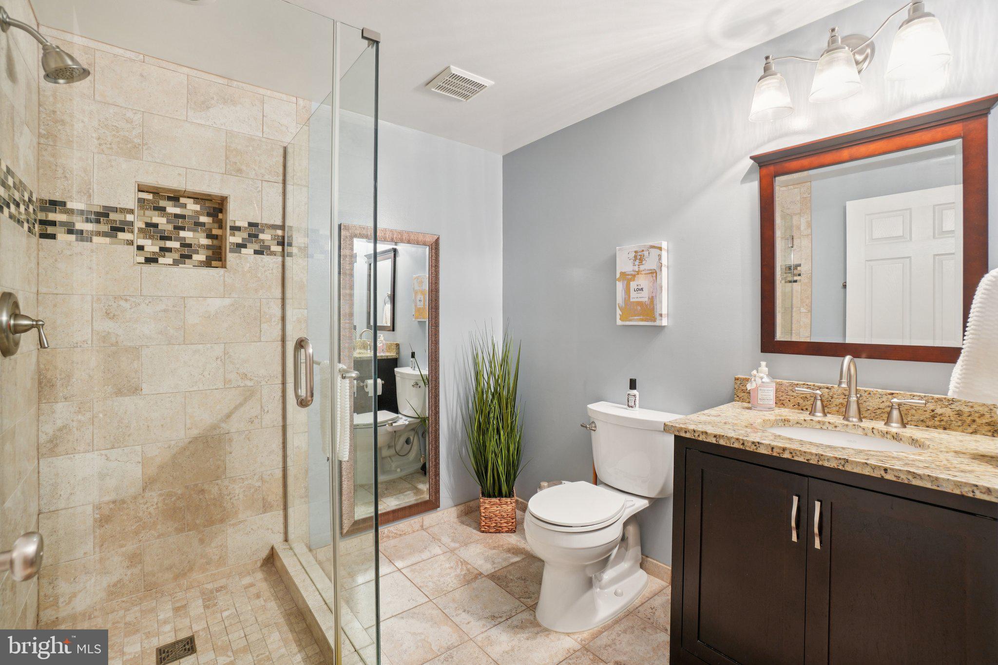 11742 Valley Ridge Circle Fairfax, VA 22033 - Photo 26 of 34 a bathroom with a sink a toilet and shower