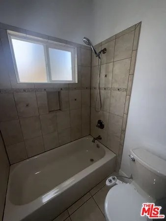 a bathroom with a bathtub and shower