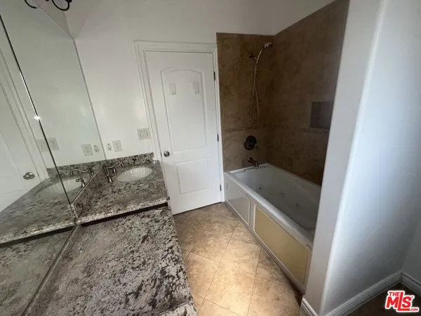 a bathroom with a tub and shower