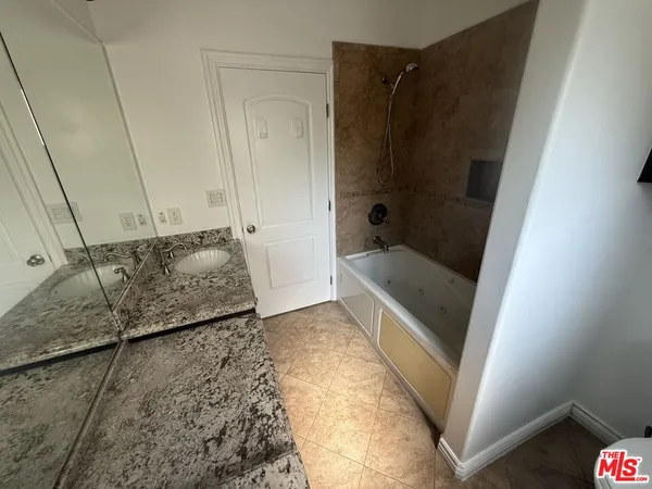 a bathroom with a tub and a sink