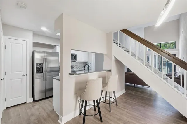 a view of entryway and hall with wooden floor