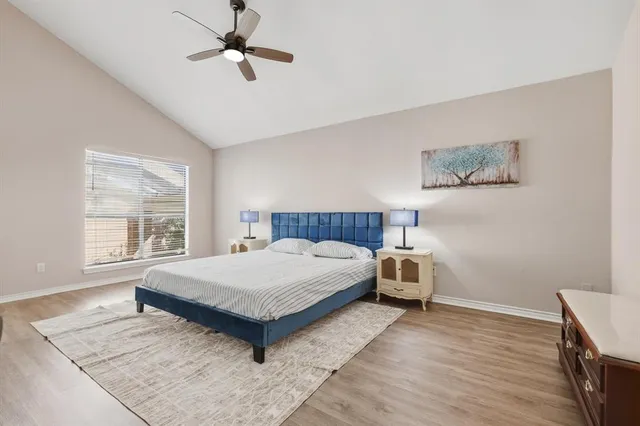 a bedroom with a large bed and a chandelier