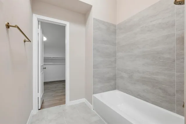 a bathroom with a bathtub and shower