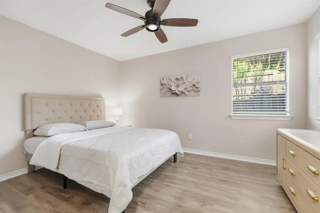 a bedroom with a large bed and a window