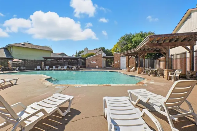 a view of a house with pool and chairs