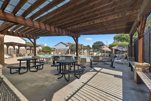 a view of a dinning table and chairs in the patio