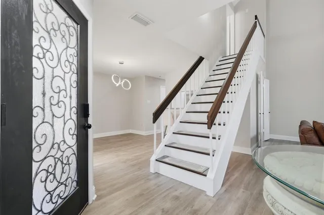a view of entryway with stairs and wooden floor