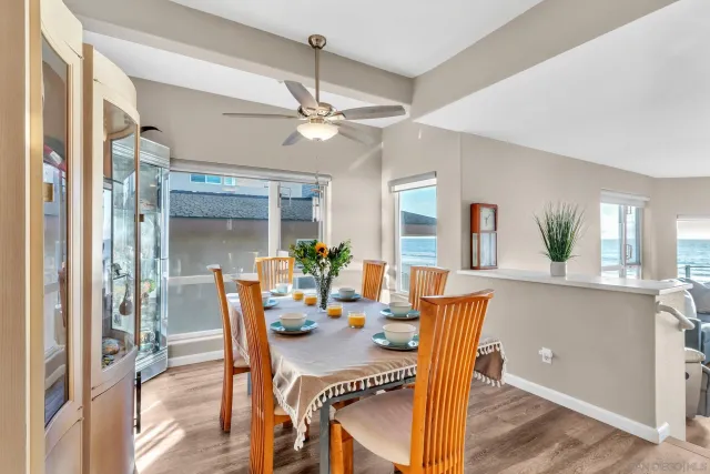 a dining room with furniture a chandelier and wooden floor