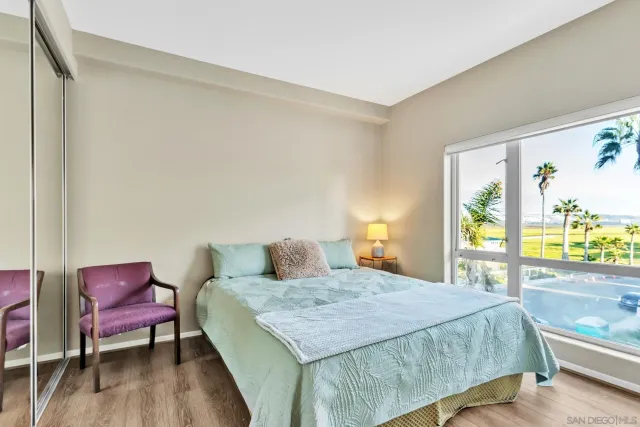 a bedroom with a bed a table and chair