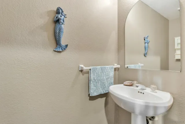 a bathroom with a sink and mirror