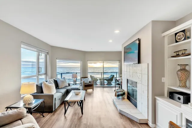 a living room with furniture large window and flat screen tv